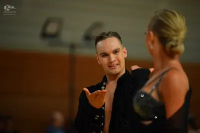 Dancesport competitor: Male dancer: black shirt with small silver embellishments
