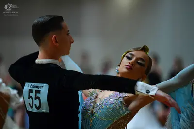 Dancesport competitor #55: Male dancer: black long-sleeved top with a white collar