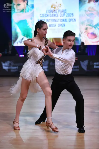Dancesport competitor: Male dancer: white long-sleeved shirt and black trousers