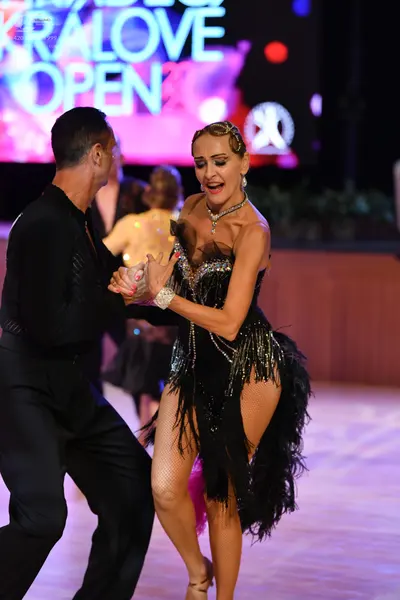 Dancesport competitor: Male dancer: black long-sleeved shirt and black trousers