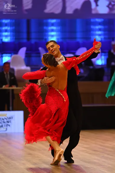 Dancesport competitor: Male dancer: black suit, white shirt, and white bow tie