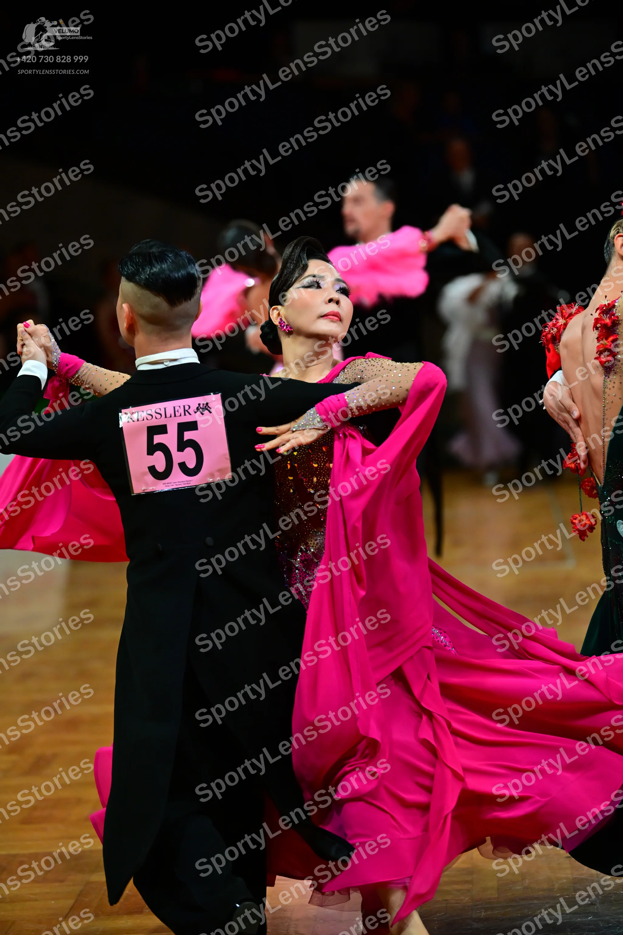 Dancesport competitor #55: Male dancer (foreground): black ballroom suit