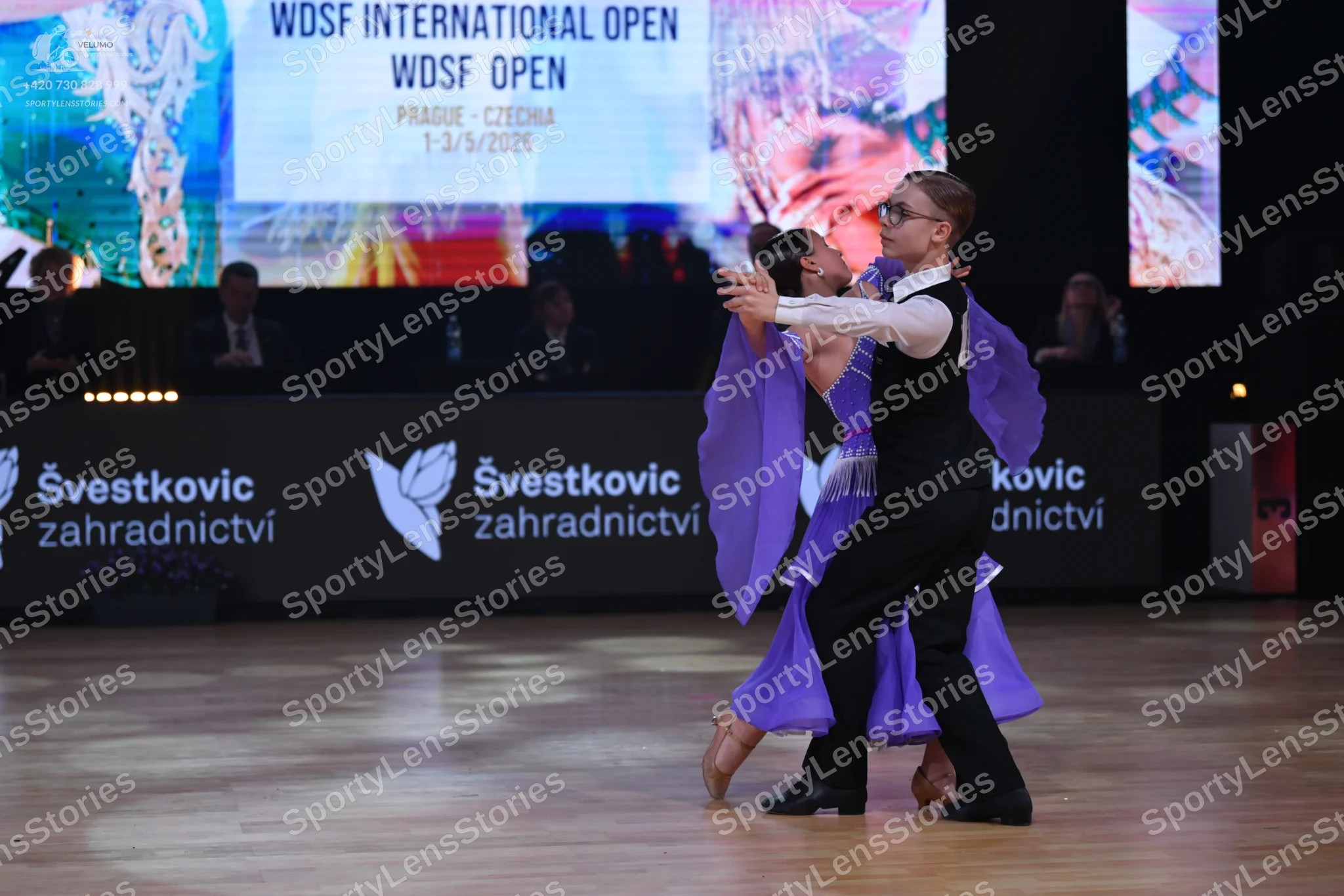 Dancesport competitor: Male dancer: black waistcoat, white long-sleeved shirt, and black trousers