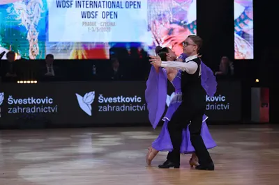 Dancesport competitor: Male dancer: black waistcoat, white long-sleeved shirt, and black trousers