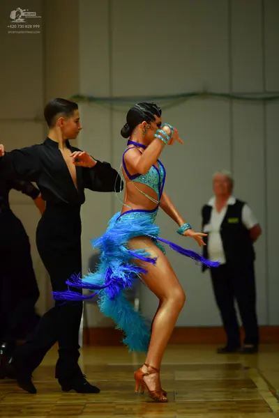 Dancesport competitor: Male dancer: black long-sleeved shirt with a deep V-neck and black trousers