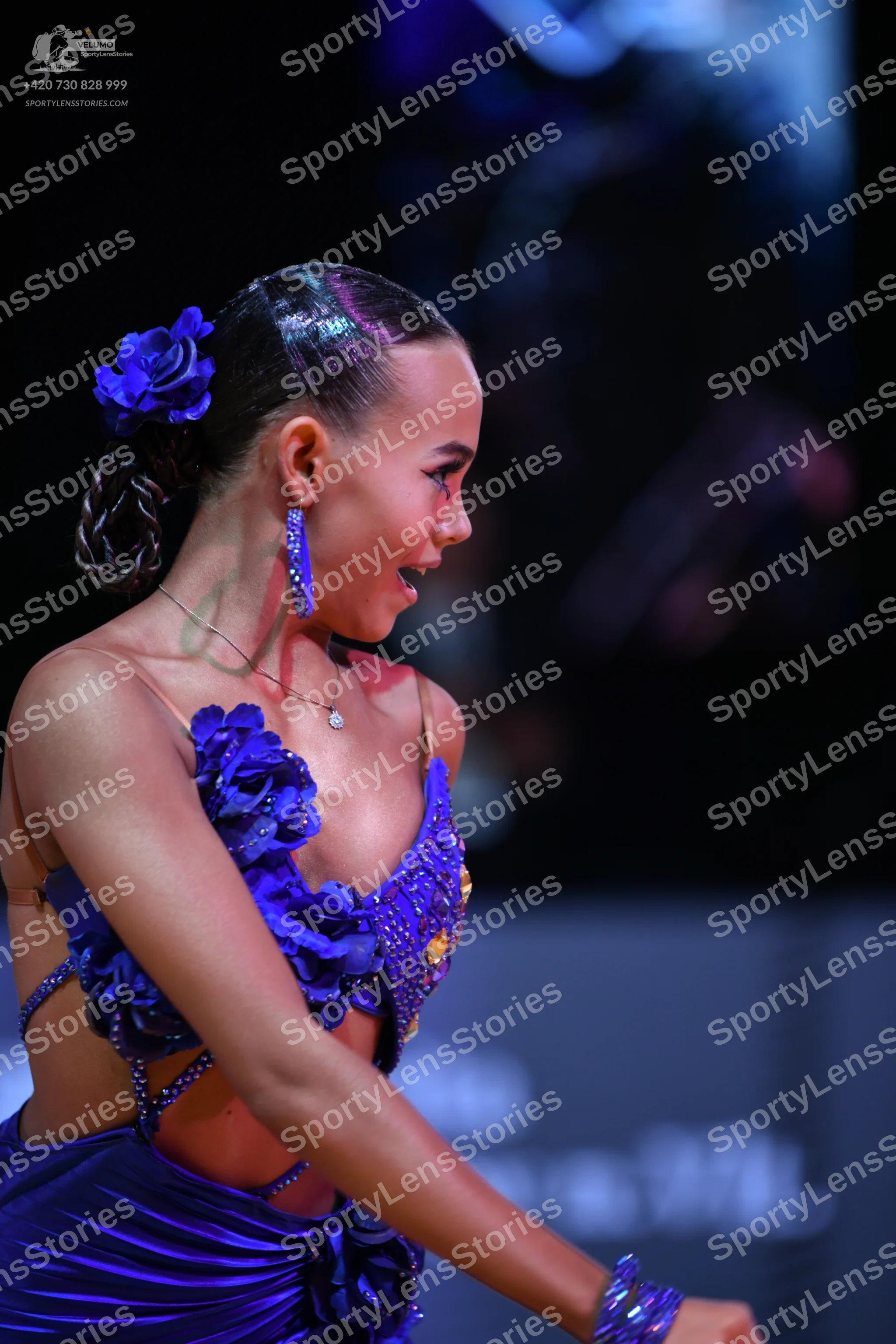 Dancesport competitor: Female dancer: deep blue latin dress with 3D floral embellishments, sequins, and