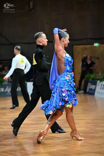 Dancesport competitor #14: Male dancer (foreground): black long-sleeved shirt and black trousers
