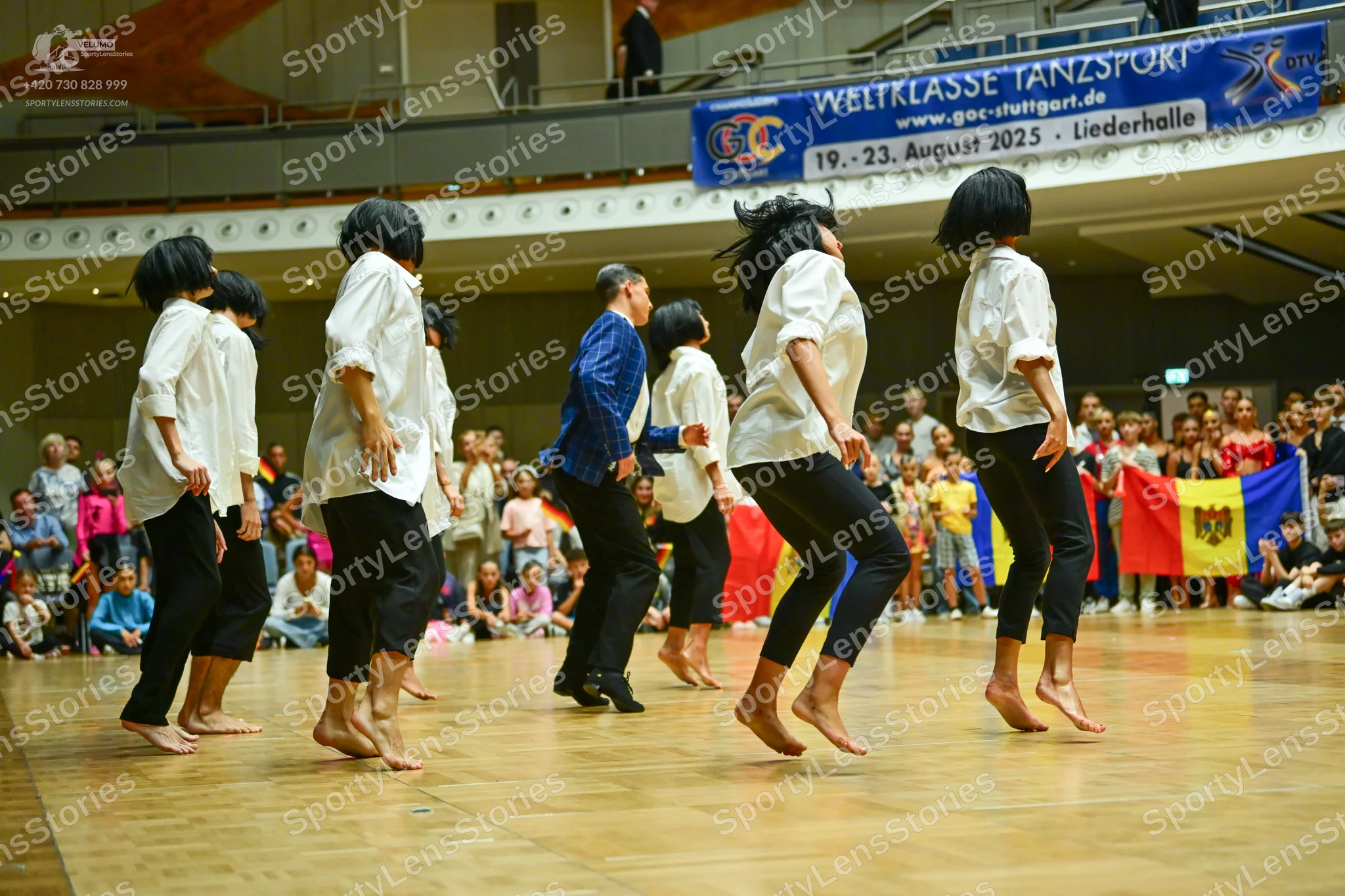 Dancesport competitor: All dancers are wearing long-sleeved button-up shirts and black trousers