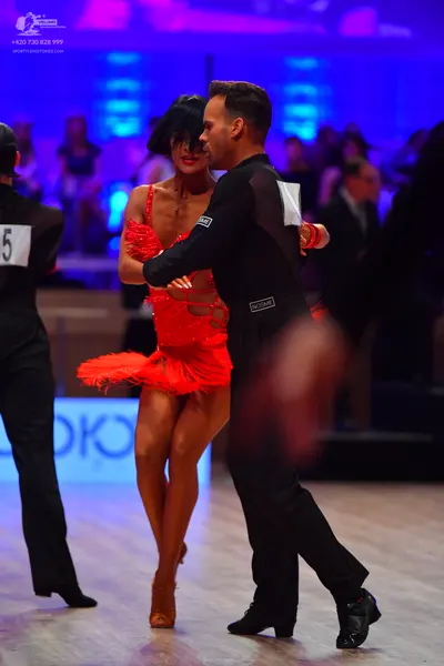 Dancesport competitor: Female dancer: red latin dress with fringe