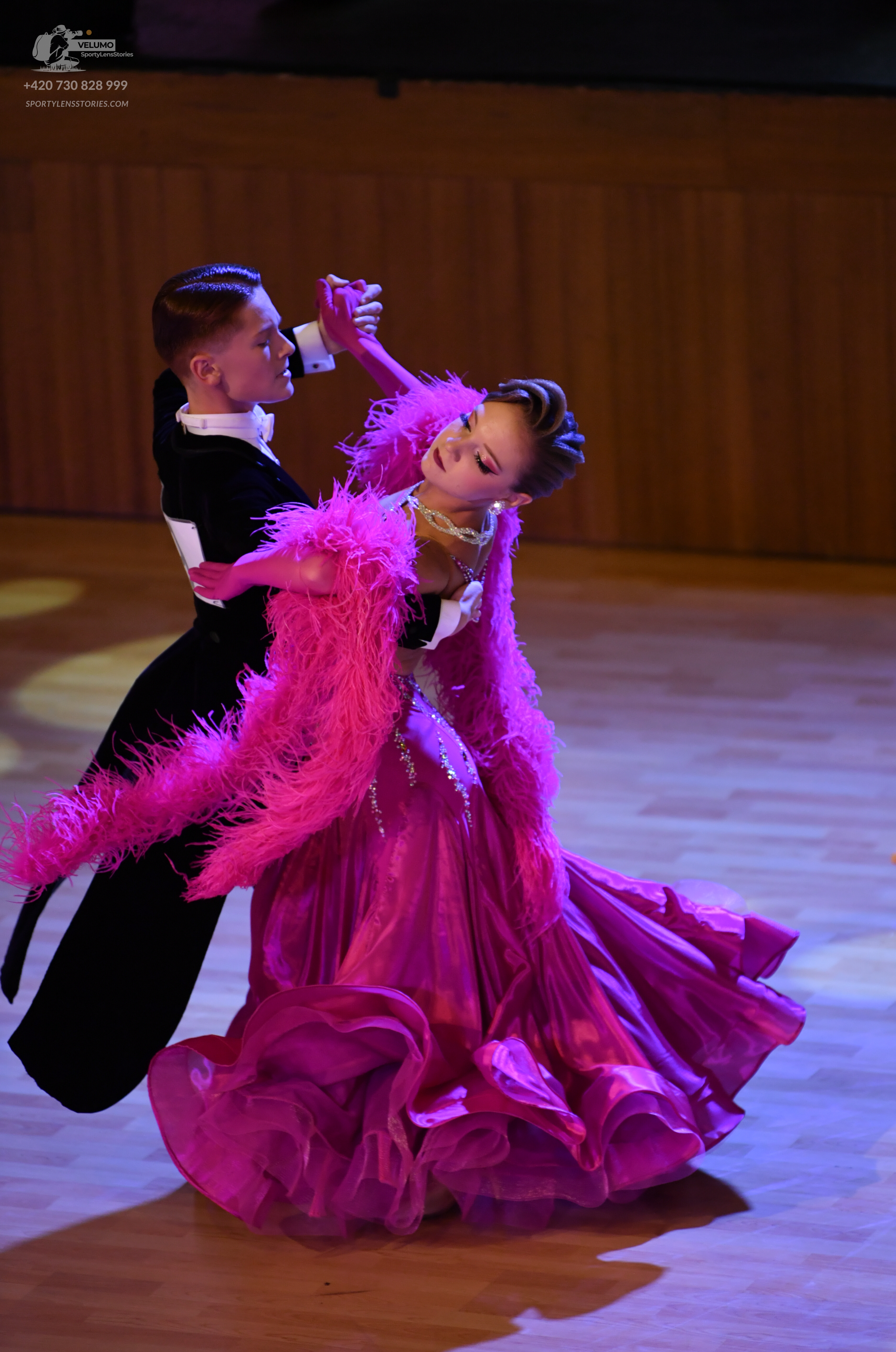 Dancesport competitor: Male:** Black tail suit with a wide, shimmering sequin lapel