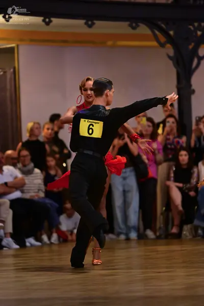Dancesport competitor: Male dancer: black long-sleeved shirt and trousers