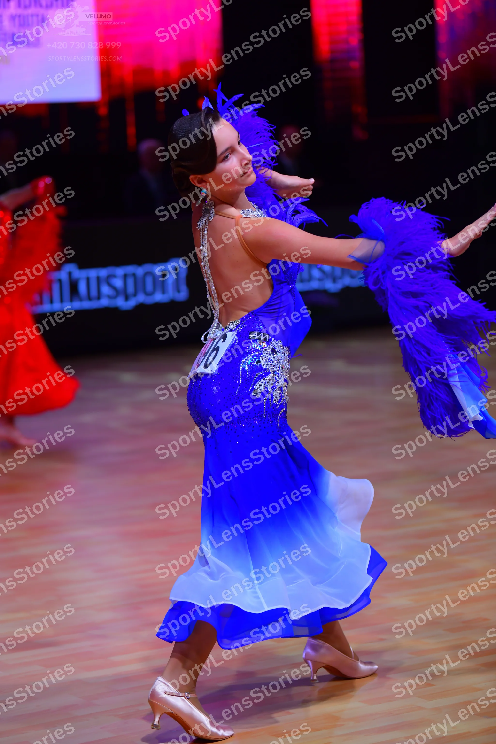 Dancesport competitor: Female dancer: blue ombré Latin dress with silver crystal embellishments and lar
