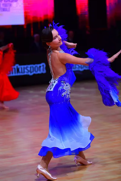 Dancesport competitor: Female dancer: blue ombré Latin dress with silver crystal embellishments and lar