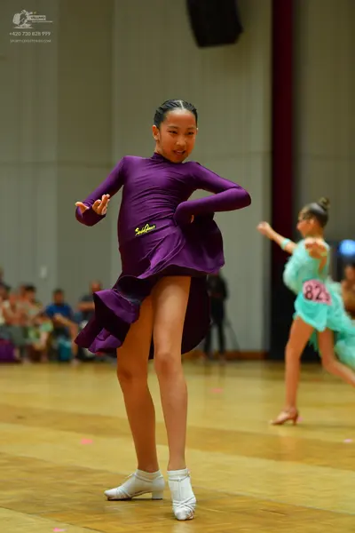 Dancesport competitor #82: Female dancer 1: purple long-sleeved latin dress