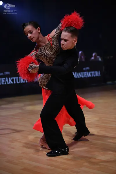 Dancesport competitor: Male dancer: black long-sleeved top and black trousers