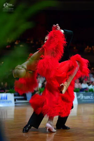 Dancesport competitor: Female dancer: red latin dress with heavy fringe
