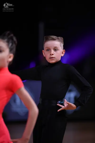 Dancesport competitor: Male dancer: black long-sleeved turtleneck and black trousers