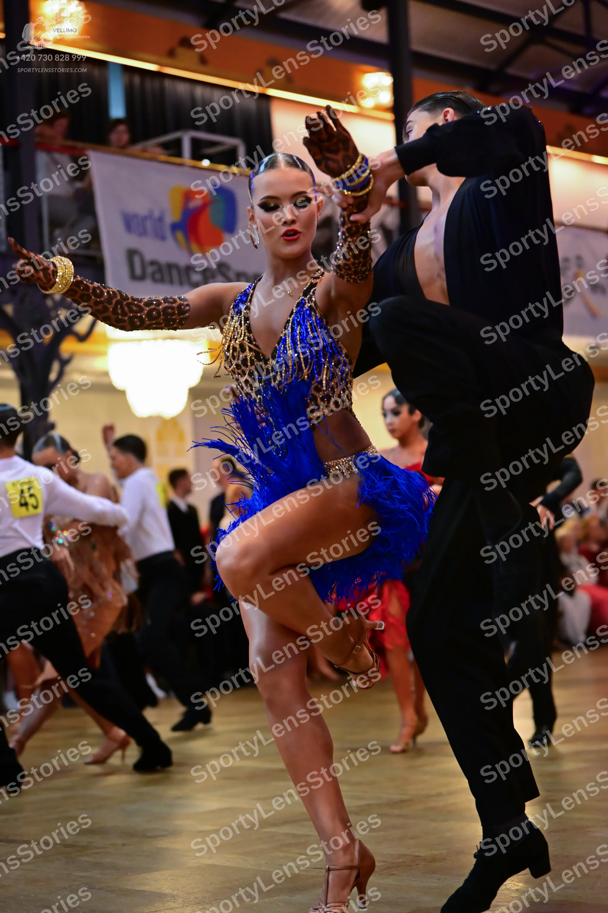 Dancesport competitor #45: Main female dancer: leopard print Latin dress with a bright blue sequined fringe