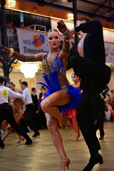 Dancesport competitor #45: Main female dancer: leopard print Latin dress with a bright blue sequined fringe