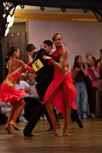 Dancesport competitor: Male dancer: black shirt and trousers