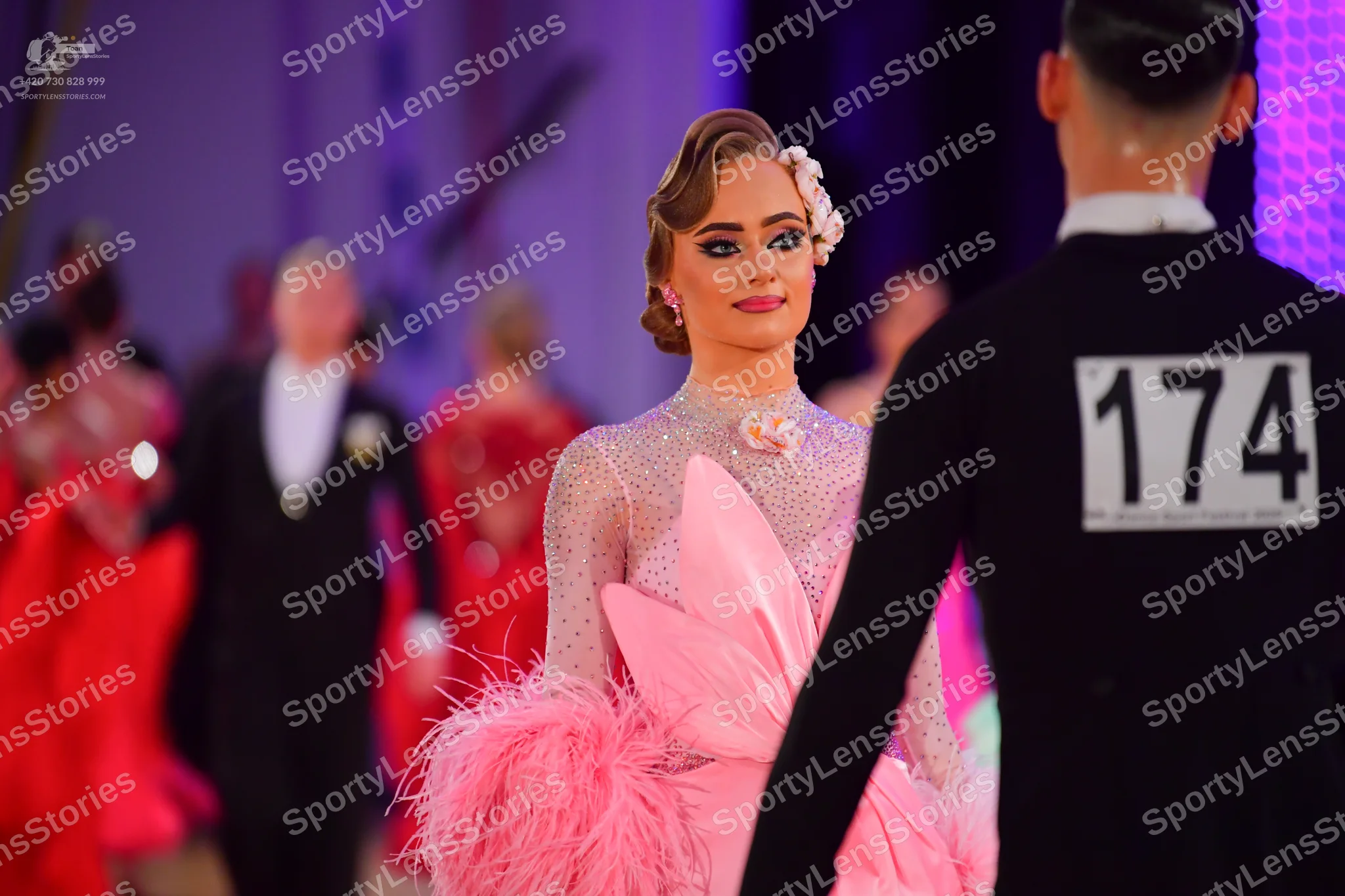 Dancesport competitor #174: Male dancer in foreground: black long-sleeved top