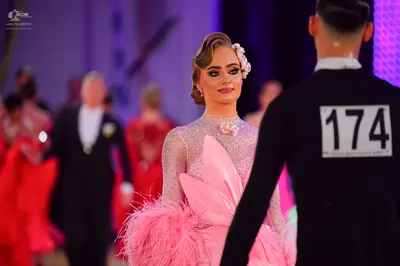 Dancesport competitor #174: Male dancer in foreground: black long-sleeved top