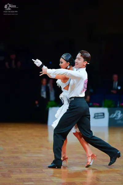 Dancesport competitor: Male dancer: white long-sleeved shirt and black dance trousers