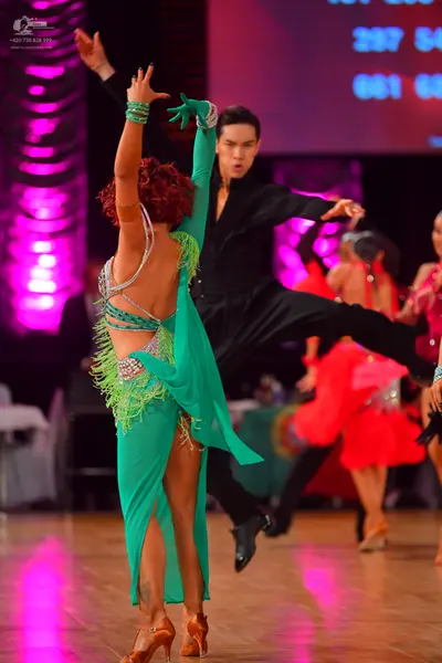 Dancesport competitor: Male dancer: black long-sleeved latin dance shirt and black trousers