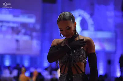 Dancesport competitor: Female dancer: black Latin dance costume with silver sequin and bead embellishme