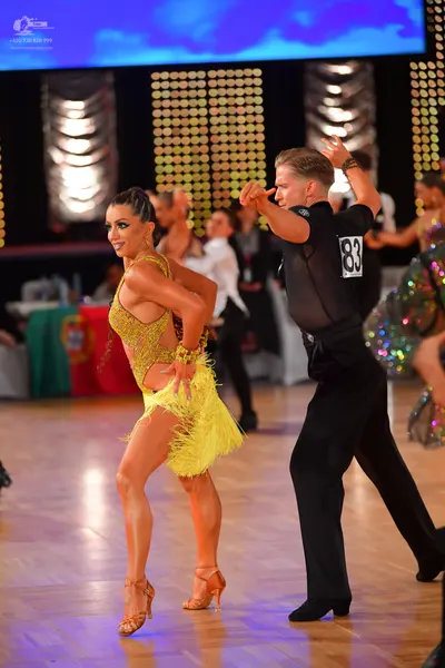 Dancesport competitor #83: Female dancer: yellow sequined Latin dress with a fringe skirt