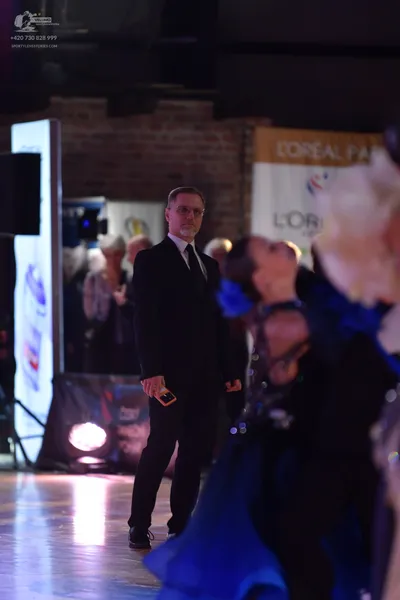 Dancesport competitor: Male dancer: black suit, white shirt, and black tie