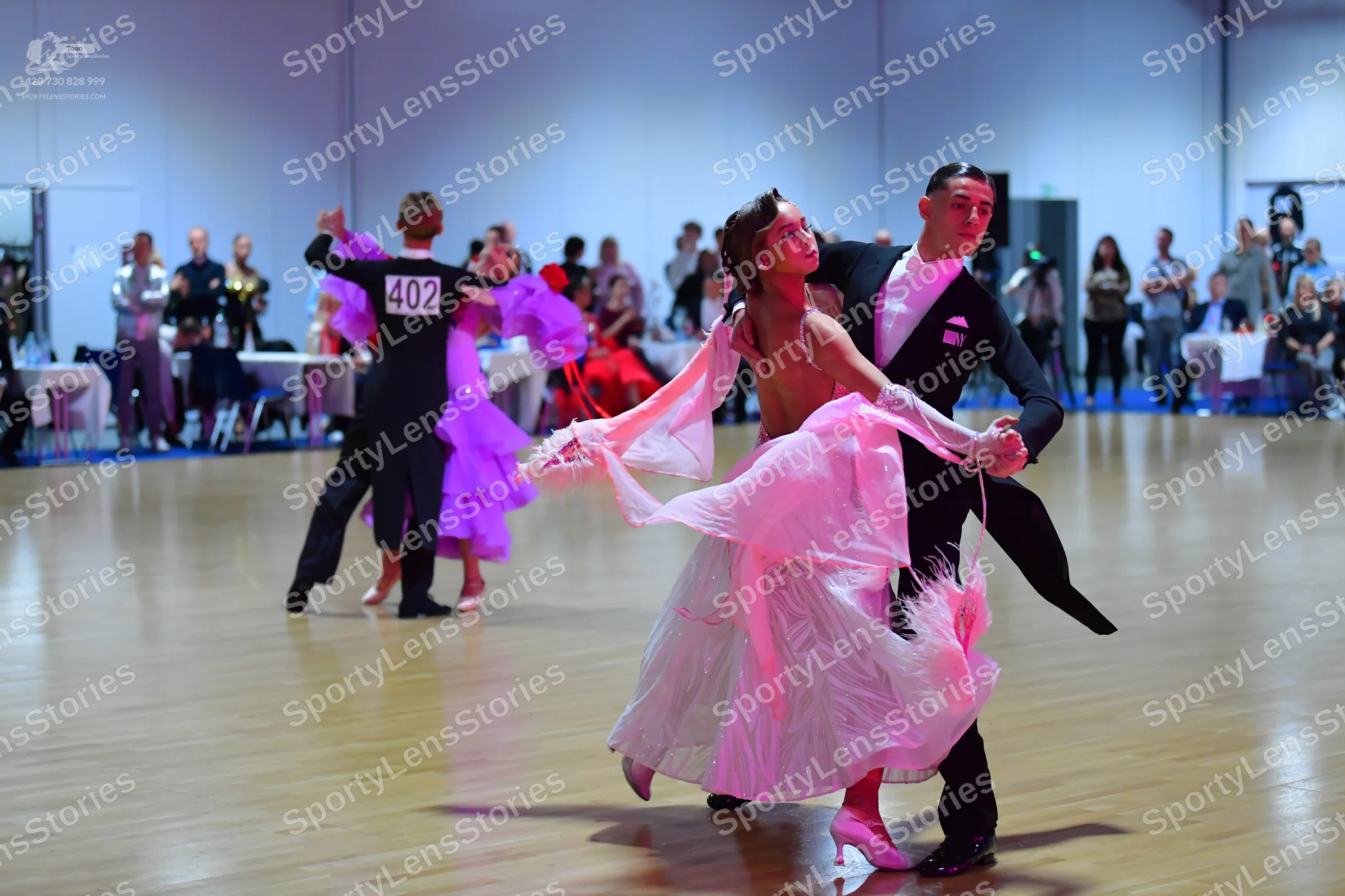 Dancesport competitor #402: Male dancer in back: black long-sleeved top and black trousers