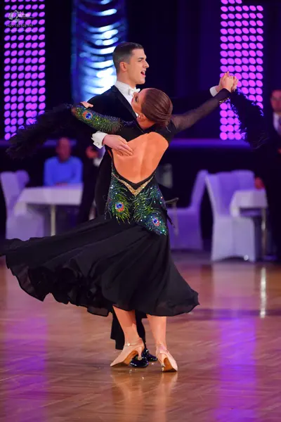 Dancesport competitor: Male dancer: black suit with a white shirt