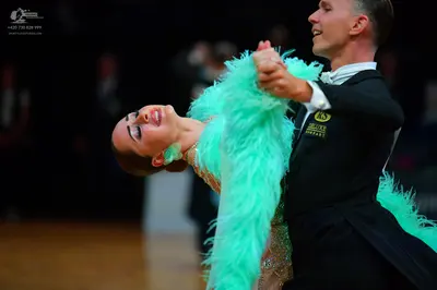 Dancesport competitor: Male dancer: black formal suit with a white shirt