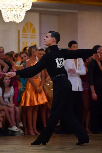 Dancesport competitor #92: Male dancer: black long-sleeved turtleneck and black trousers