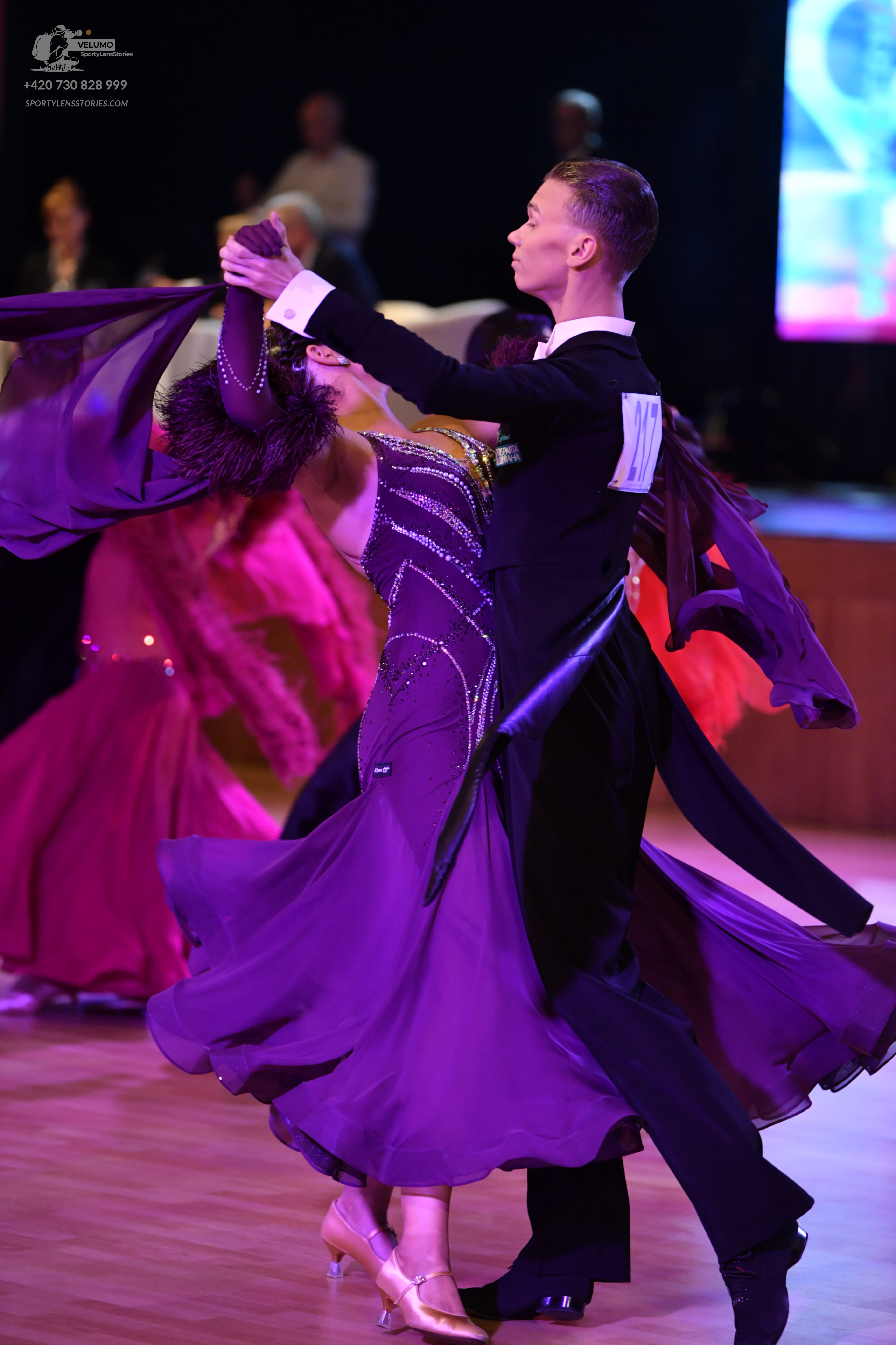 Dancesport competitor: Male dancer: black long-sleeved dance shirt with white cuffs