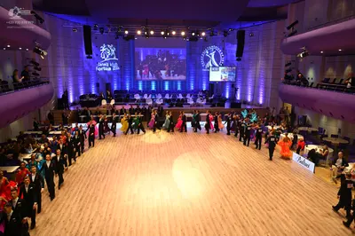 Dancesport competitor: Male dancers: black or dark suits with white shirts, some featuring satin or seq