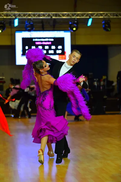 Dancesport competitor: Male dancer: Black suit with a white dress shirt