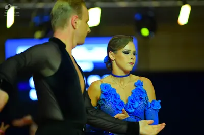 Dancesport competitor: Male dancer: black dance top with sheer sleeves