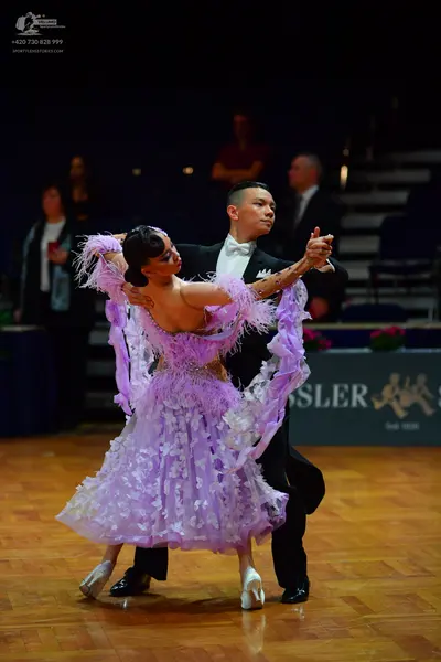 Dancesport competitor: Female dancer: lilac latin dress with voluminous layered ruffled tulle and flora