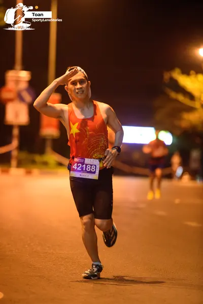 Marathon runner #42188: Runner 1: red tank top with yellow star, black shorts, black running shoes, whit