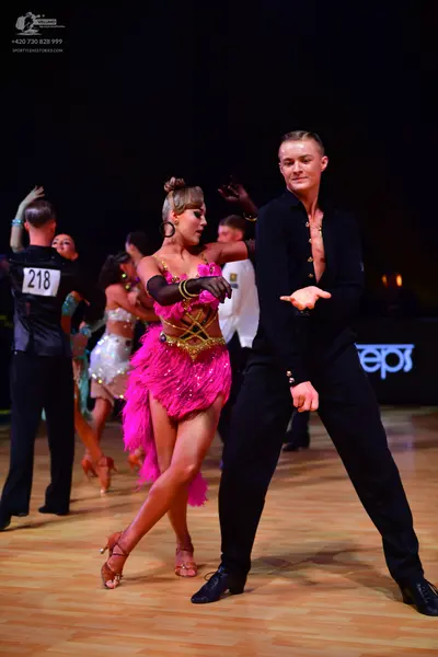 Dancesport competitor: Male dancer: black long-sleeved shirt with small crystals and black trousers