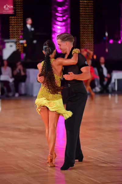 Dancesport competitor: Male dancer: black short-sleeved shirt with small sequins on the sleeve and blac