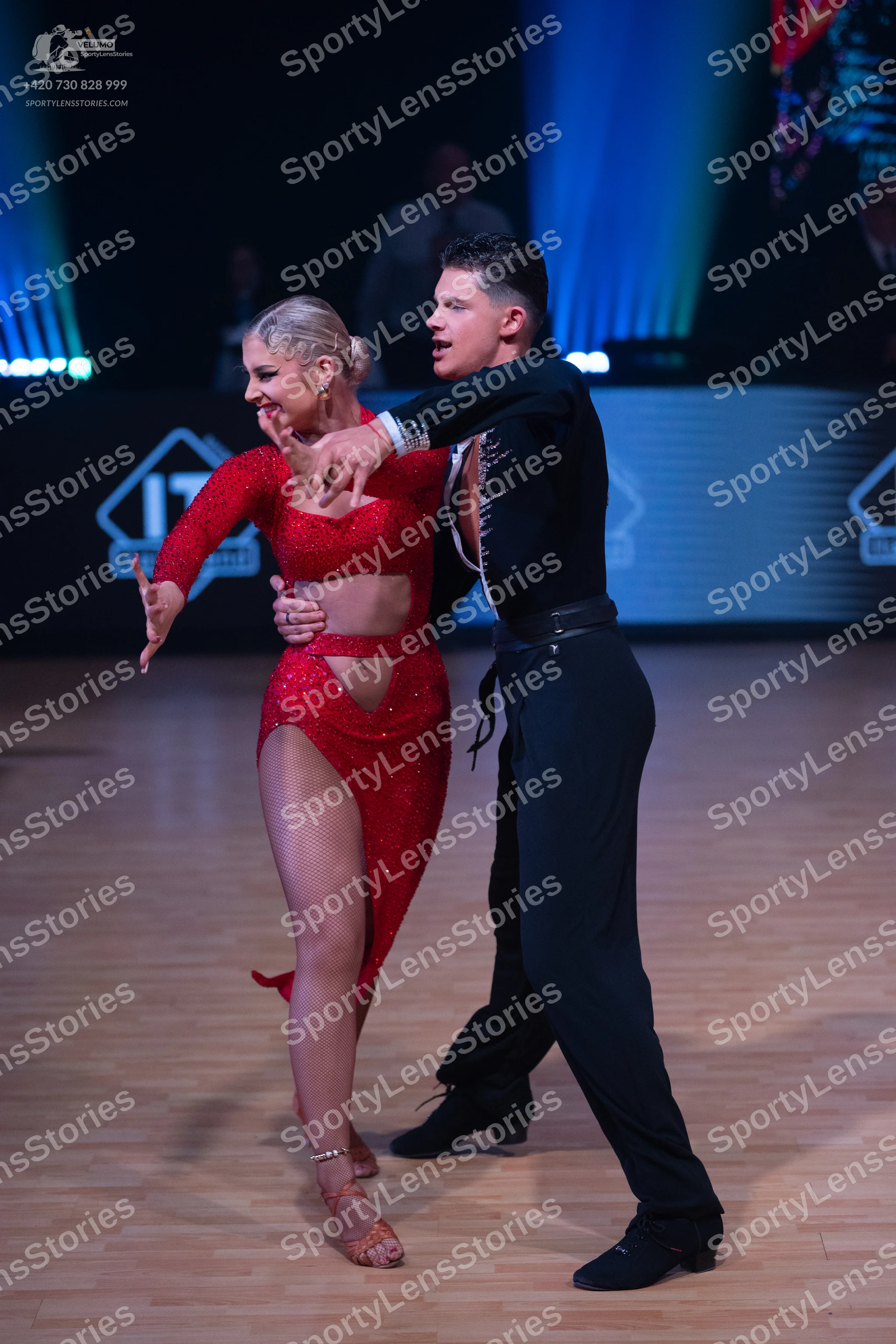 Dancesport competitor: Female dancer: red sequined latin dress with cut-outs and a high slit