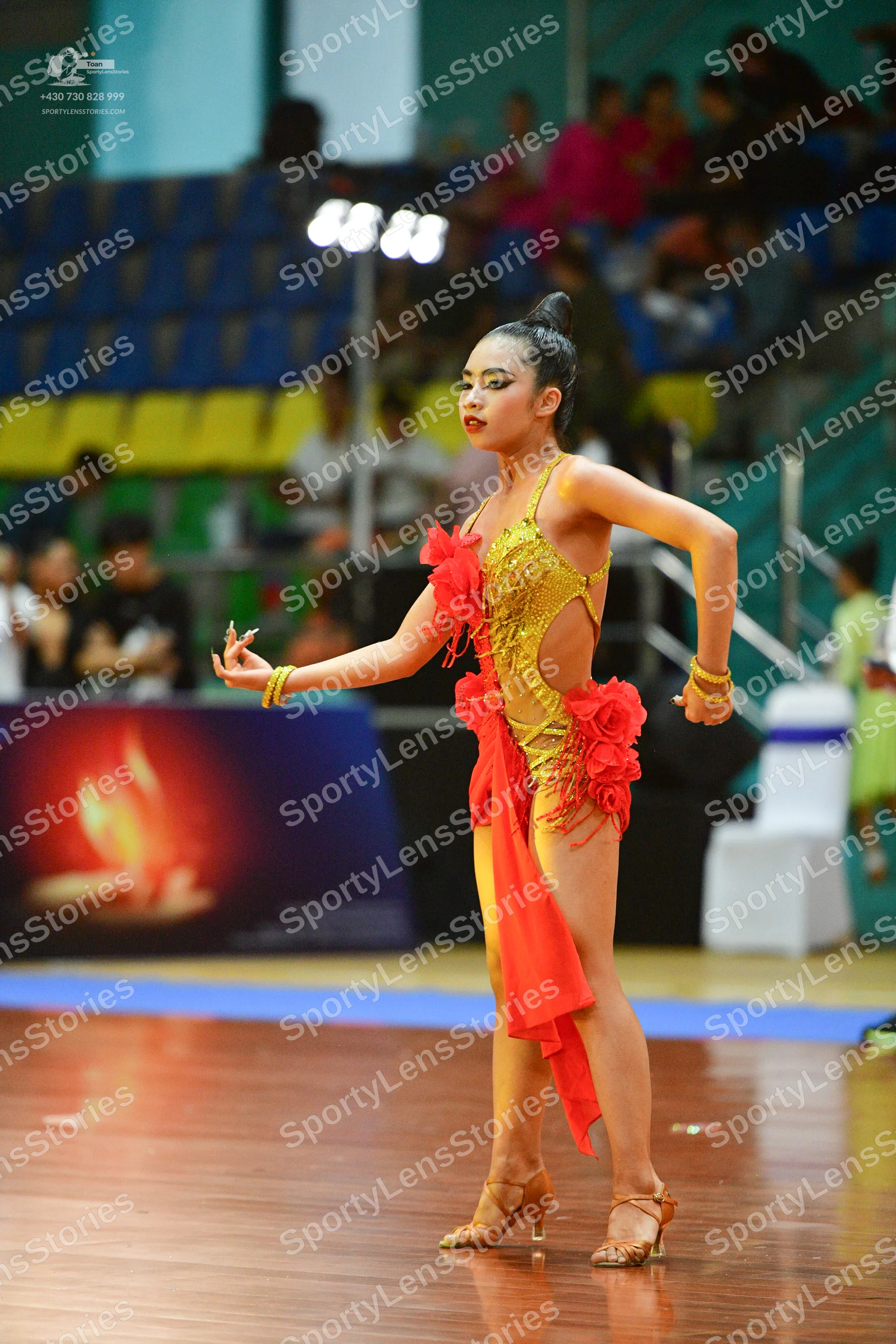 Dancesport competitor: ** Red Latin dress
*   **Color:** Primarily a vibrant red