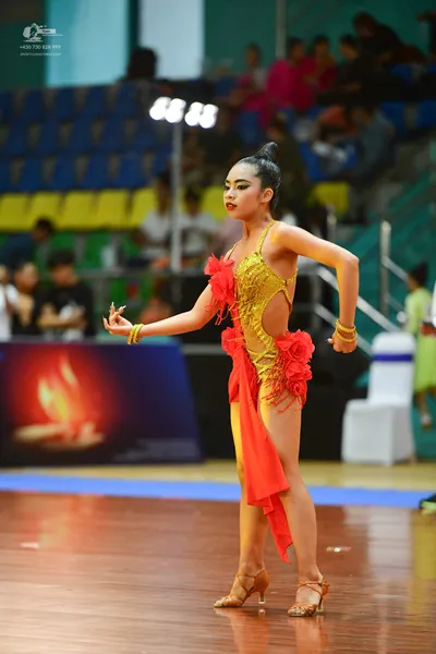 Dancesport competitor: ** Red Latin dress
*   **Color:** Primarily a vibrant red