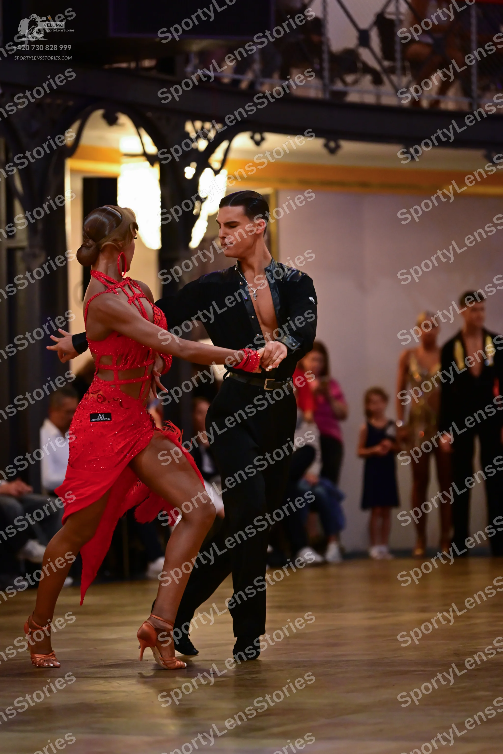 Dancesport competitor: Female dancer: red latin dress with sequins and cutouts