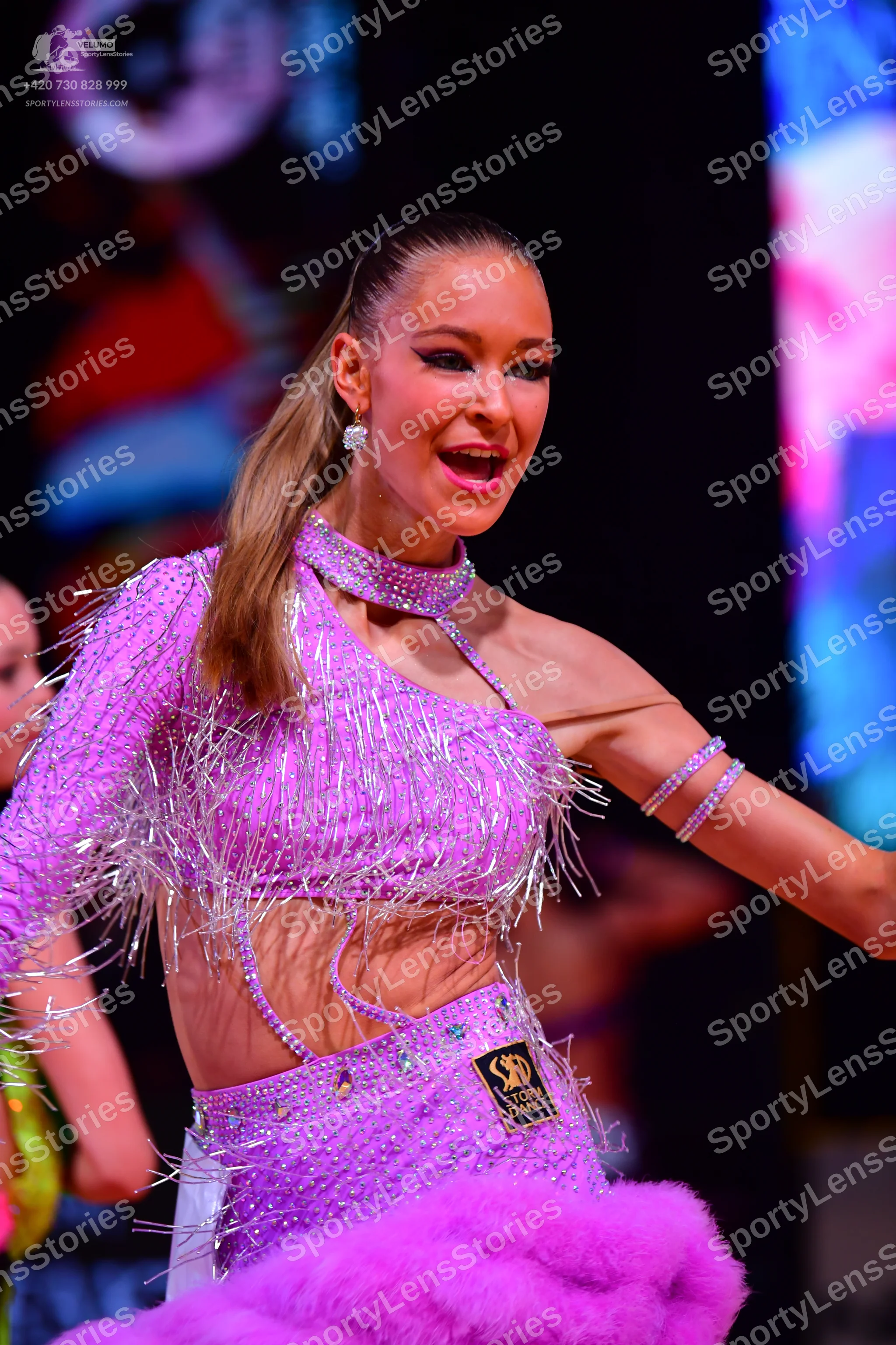 Dancesport competitor: Female dancer: light purple sequined Latin dance dress with long fringe, featuri