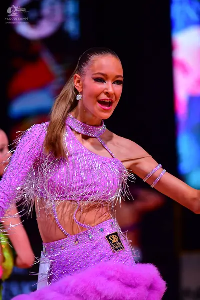 Dancesport competitor: Female dancer: light purple sequined Latin dance dress with long fringe, featuri