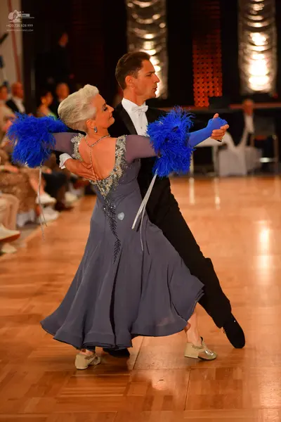 Dancesport competitor: Male dancer: black suit with a white shirt and white bow tie